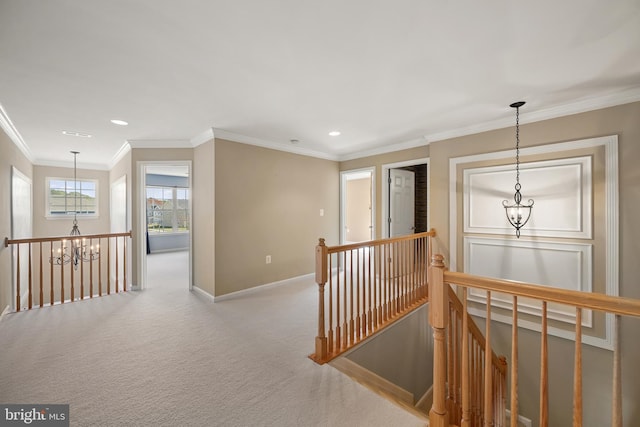 hallway with baseboards, a notable chandelier, an upstairs landing, and carpet