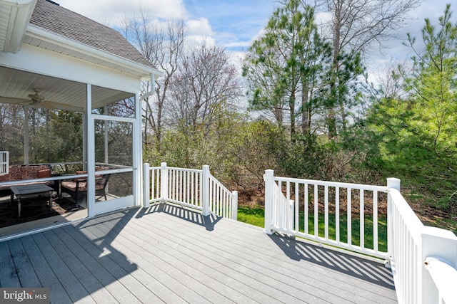 deck with ceiling fan and a sunroom