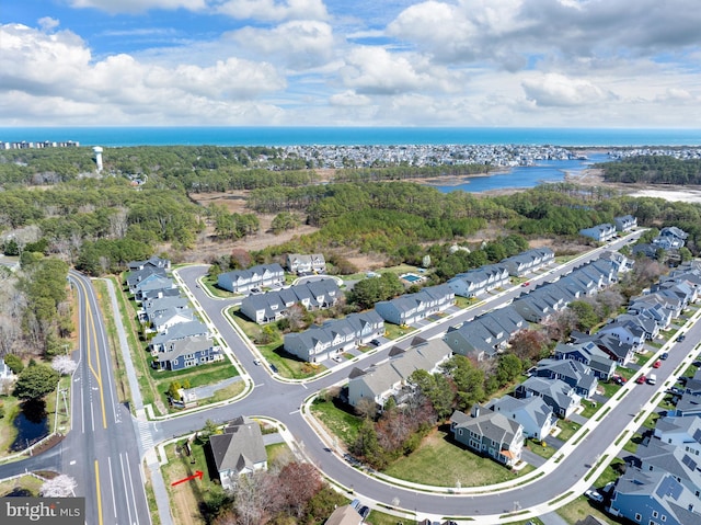 drone / aerial view featuring a water view and a residential view