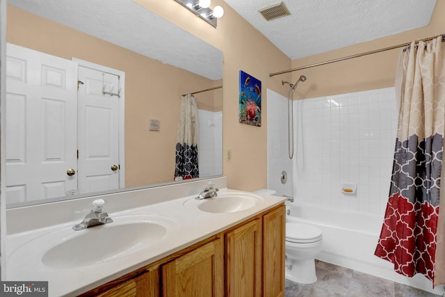 bathroom with a sink, a textured ceiling, shower / tub combo with curtain, and visible vents