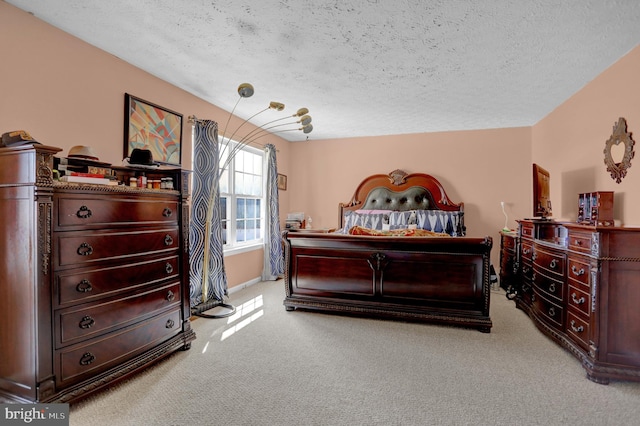 bedroom featuring carpet floors and a textured ceiling