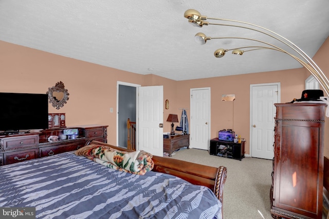 carpeted bedroom featuring a textured ceiling