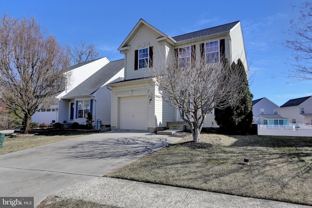 traditional-style home featuring a front yard, concrete driveway, and an attached garage