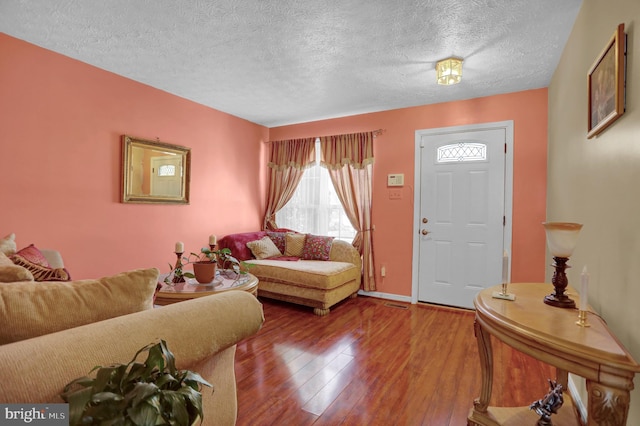 living area featuring hardwood / wood-style flooring and a textured ceiling
