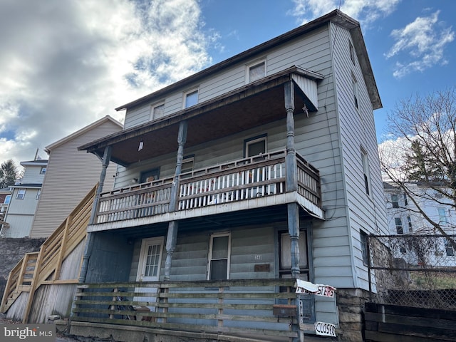 exterior space featuring a balcony and covered porch