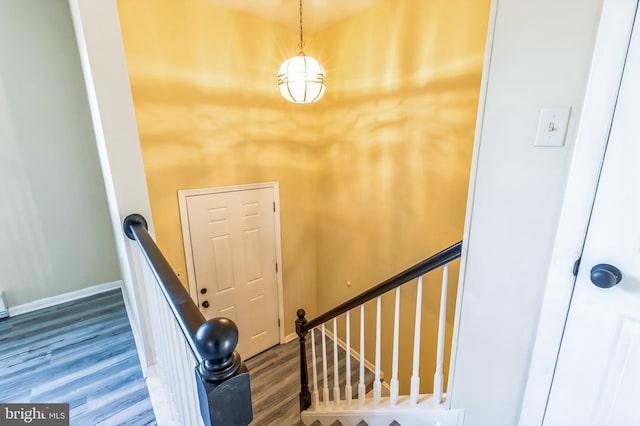 stairs featuring baseboards and wood finished floors