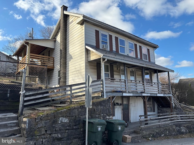 358-362 Stoney Batter, Bellefonte, PA 16823 - view of front facade with metal roof, fence, stairs, a chimney, and a porch