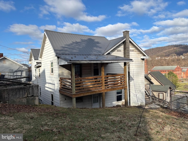 358-362 Stoney Batter, Bellefonte, PA 16823 - back of house with a chimney, a lawn, fence, and metal roof