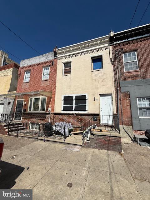 rear view of property with brick siding