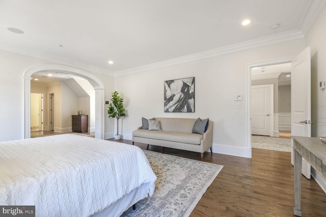 bedroom featuring crown molding, recessed lighting, baseboards, dark wood finished floors, and arched walkways