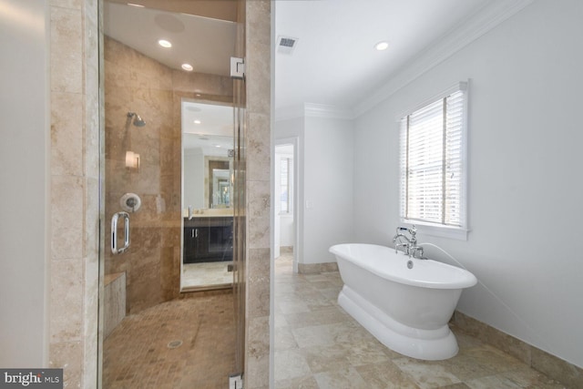 bathroom with vanity, crown molding, a shower stall, visible vents, and a freestanding bath