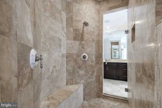 bathroom with vanity and tiled shower