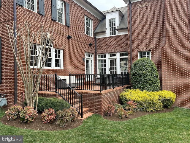 back of property featuring brick siding