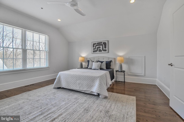 bedroom with baseboards, dark wood-style flooring, and vaulted ceiling