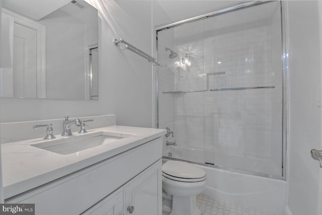 bathroom with toilet, tile patterned floors, vanity, and enclosed tub / shower combo