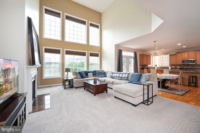 16647 Space More Cir, Woodbridge, VA 22191 - living room featuring a high ceiling, a premium fireplace, recessed lighting, and baseboards