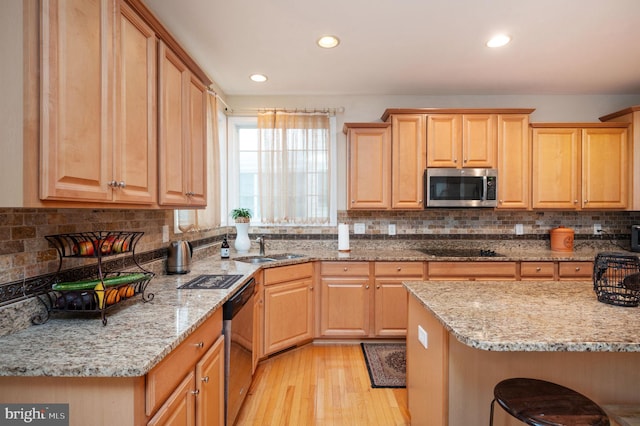 16647 Space More Cir, Woodbridge, VA 22191 - kitchen with stainless steel microwave, black electric stovetop, light wood finished floors, dishwasher, and decorative backsplash