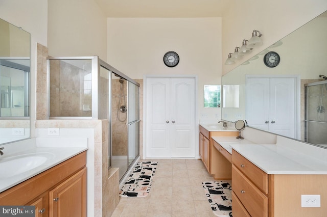16647 Space More Cir, Woodbridge, VA 22191 - bathroom featuring a stall shower, tile patterned floors, and two vanities