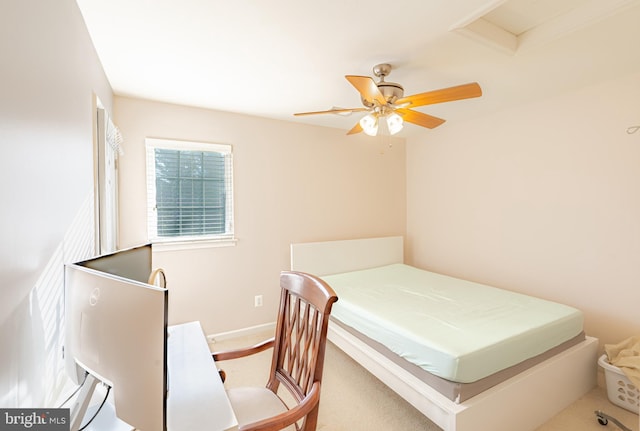 carpeted bedroom featuring baseboards and ceiling fan