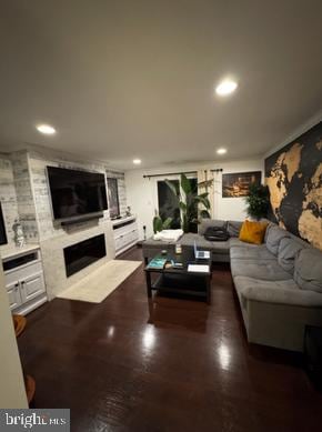 living room with a fireplace and recessed lighting