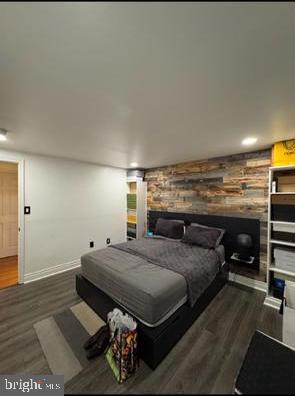 1854 Dutch Village Dr Unit R-270, Hyattsville, MD 20785 - bedroom featuring an accent wall, baseboards, a fireplace, and wood finished floors