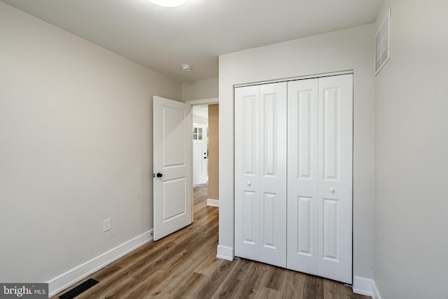 1198 Glenside Rd, Downingtown, PA 19335 - unfurnished bedroom featuring visible vents, a closet, baseboards, and wood finished floors