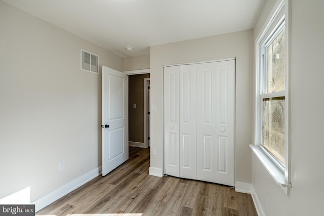 1198 Glenside Rd, Downingtown, PA 19335 - unfurnished bedroom featuring visible vents, baseboards, a closet, and wood finished floors