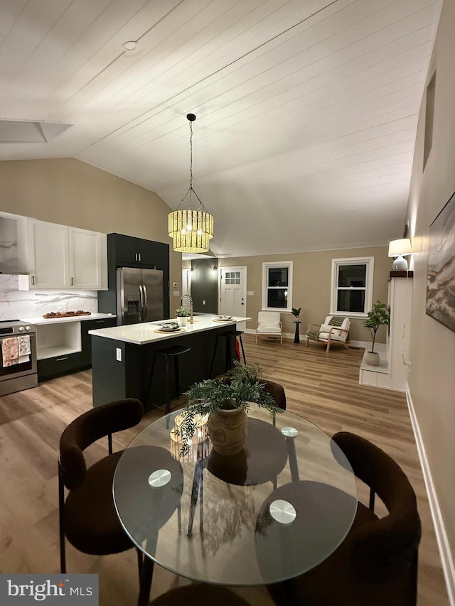 1198 Glenside Rd, Downingtown, PA 19335 - dining area with vaulted ceiling, wooden ceiling, light wood finished floors, baseboards, and a notable chandelier