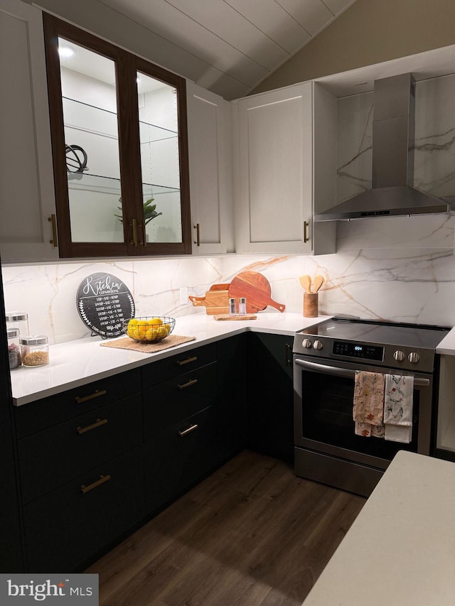 1198 Glenside Rd, Downingtown, PA 19335 - kitchen featuring wall chimney exhaust hood, stainless steel range with electric stovetop, light countertops, dark wood-style floors, and vaulted ceiling