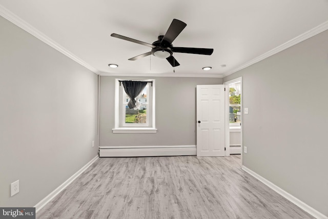 unfurnished room with crown molding, baseboards, and a baseboard heating unit