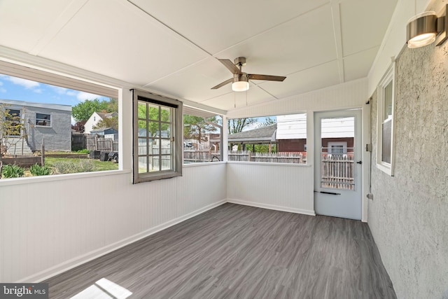 unfurnished sunroom featuring ceiling fan
