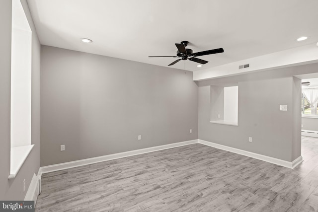 unfurnished room featuring a ceiling fan, visible vents, wood finished floors, and recessed lighting