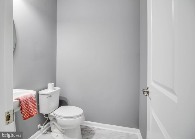 1634 Cape May Rd, Essex, MD 21221 - bathroom featuring baseboards, toilet, and marble finish floor