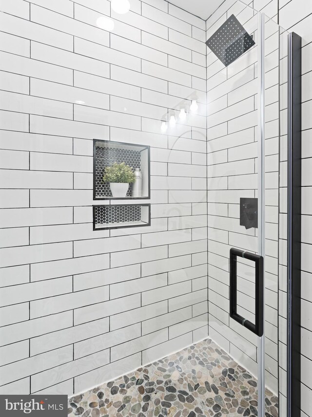 1611 N Dover St, Philadelphia, PA 19121 - bathroom featuring a shower stall and stone finish flooring