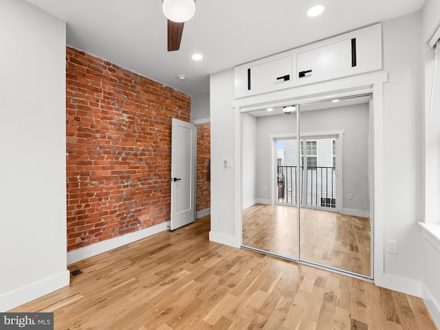 1611 N Dover St, Philadelphia, PA 19121 - unfurnished bedroom with access to outside, recessed lighting, light wood-style floors, brick wall, and baseboards