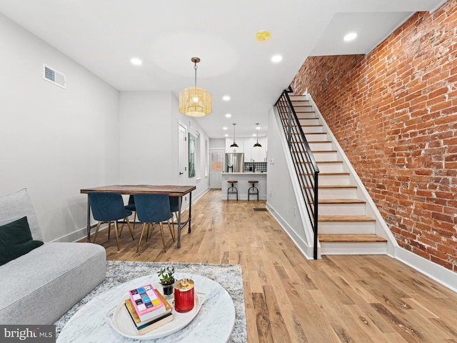 1611 N Dover St, Philadelphia, PA 19121 - living area featuring stairway, visible vents, brick wall, recessed lighting, and light wood-type flooring