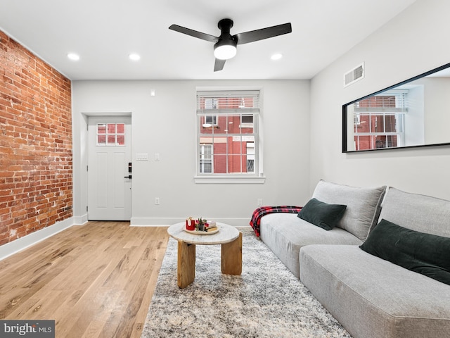 1611 N Dover St, Philadelphia, PA 19121 - living area featuring visible vents, brick wall, ceiling fan, baseboards, and light wood-style floors