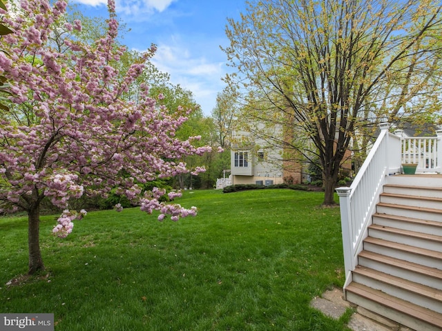 view of green lawn with stairs