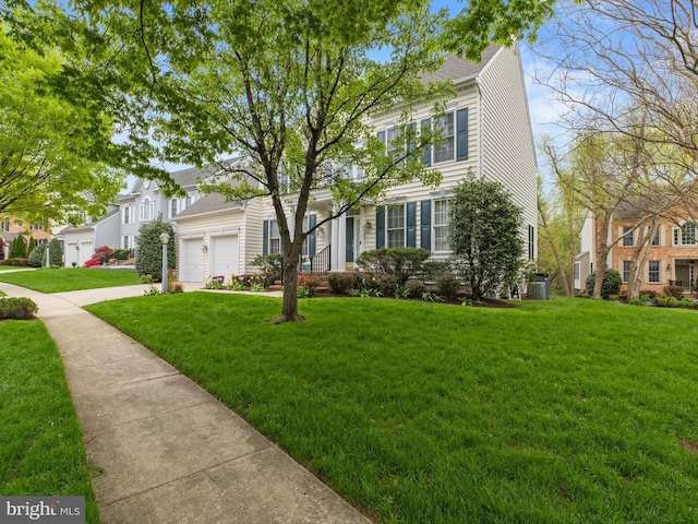 view of front of house with a front lawn, driveway, and an attached garage