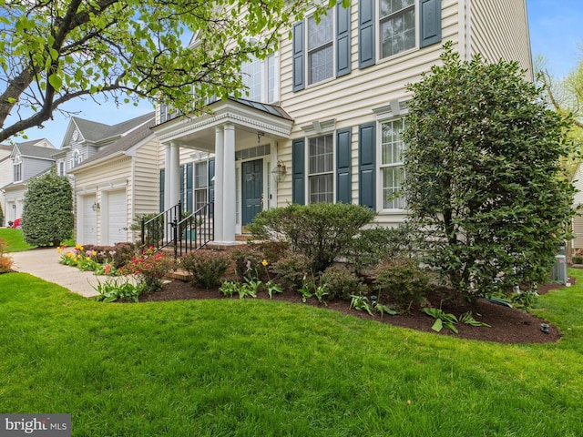 view of side of home with a yard and a garage