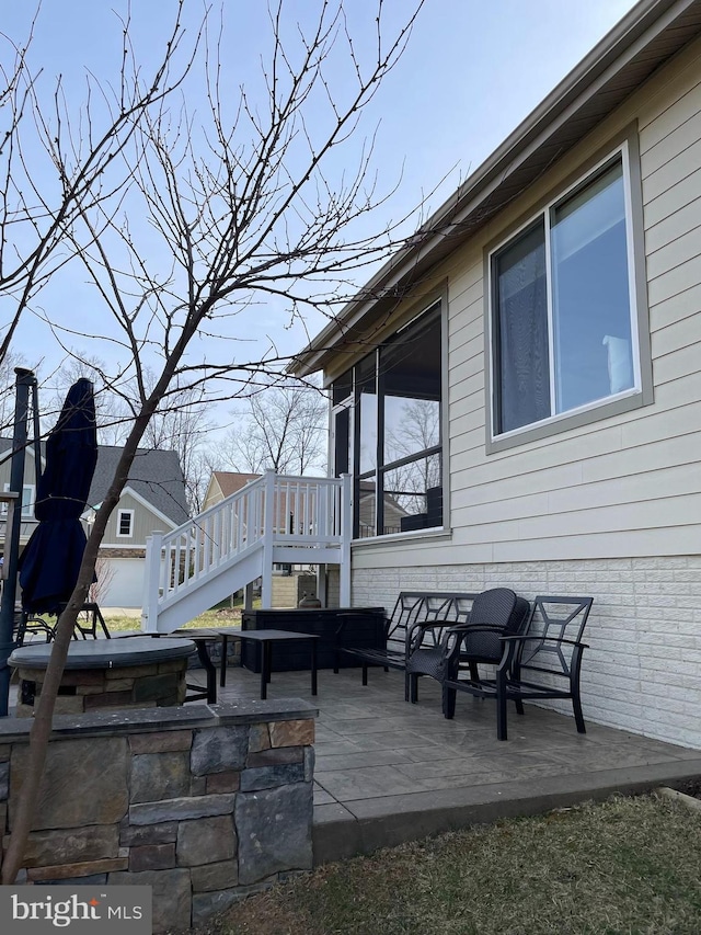 view of patio with a deck and stairway