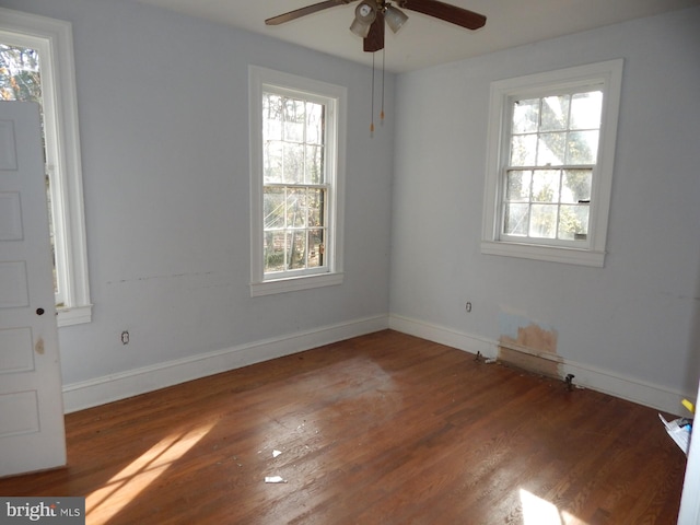 605 Upland Rd, Pikesville, MD 21208 - empty room with plenty of natural light, baseboards, ceiling fan, and wood finished floors