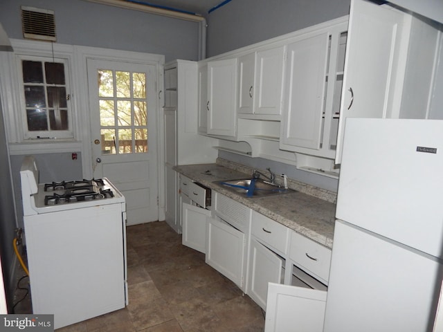 605 Upland Rd, Pikesville, MD 21208 - kitchen with white appliances, visible vents, a sink, light countertops, and white cabinets