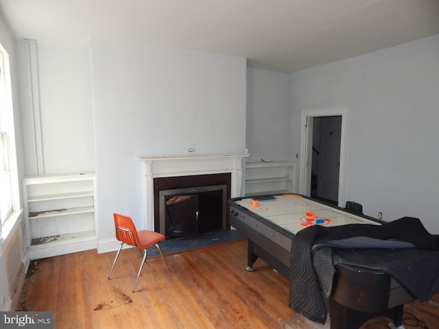 605 Upland Rd, Pikesville, MD 21208 - playroom featuring a fireplace with flush hearth and wood finished floors