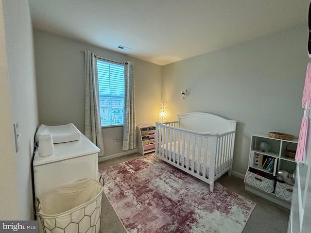 17692 Fieldstone Ave, Milford, DE 19963 - carpeted bedroom with baseboards, visible vents, and a crib