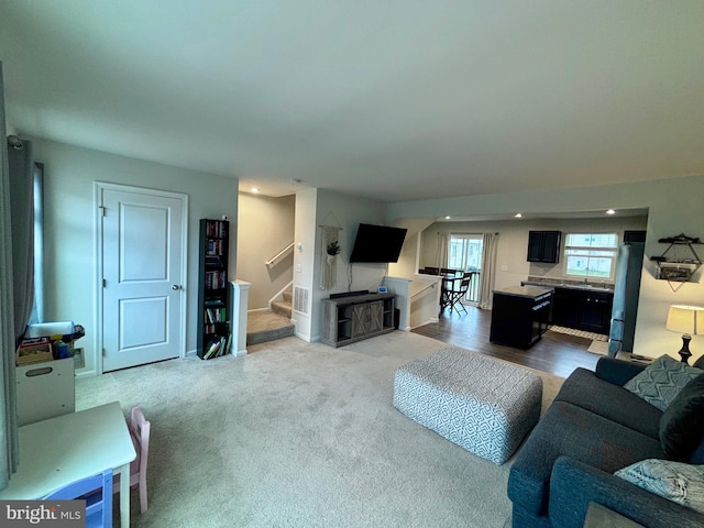 17692 Fieldstone Ave, Milford, DE 19963 - carpeted living area with stairs, baseboards, and a sink