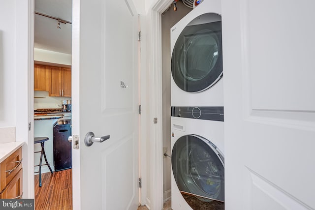 440 L St NW Unit 513, Washington, DC 20001 - laundry room featuring stacked washer and clothes dryer, light wood-style floors, and laundry area