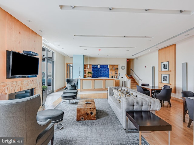 440 L St NW Unit 513, Washington, DC 20001 - living room featuring stairs, light wood-style floors, and a fireplace