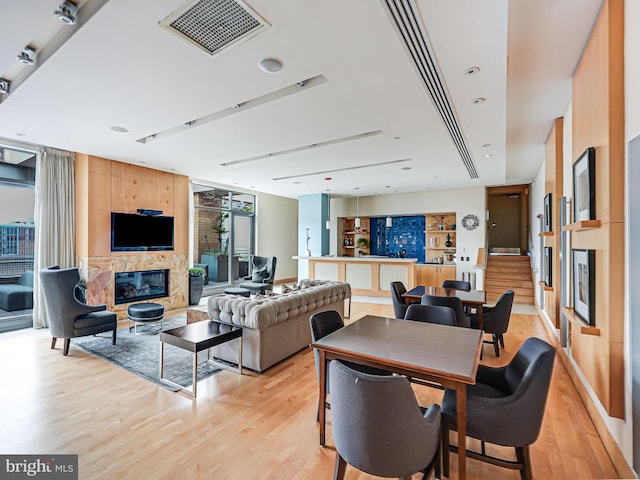 440 L St NW Unit 513, Washington, DC 20001 - dining room with a glass covered fireplace, light wood-style floors, and visible vents