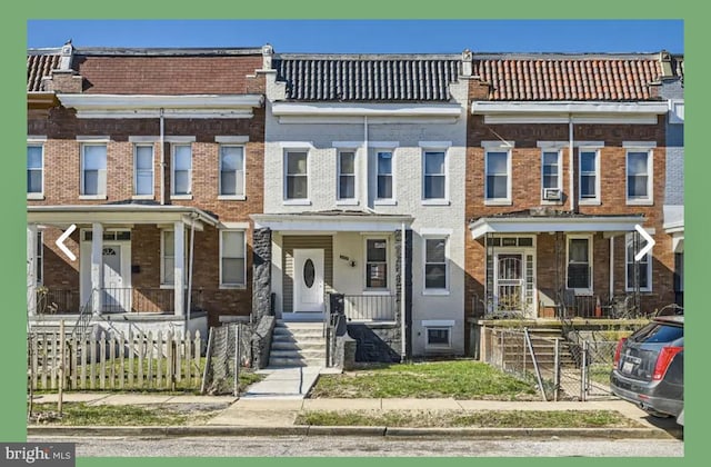 multi unit property with brick siding and fence